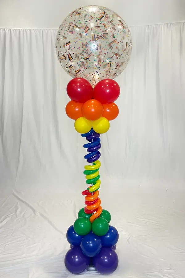 7.5ft tall column with squiggle accents and rainbow confetti filled topper
