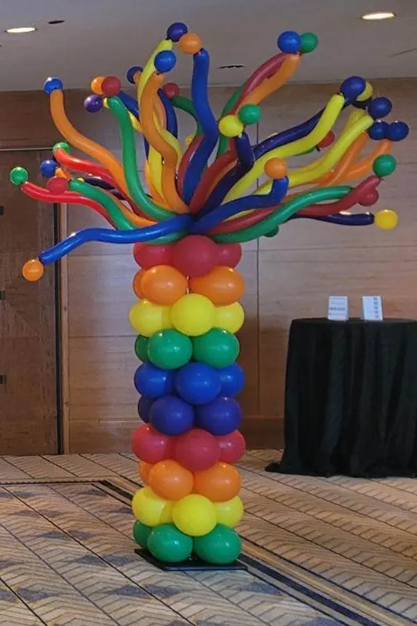 9ft tall column with a fun wiggled topper with mini balloons attached to the ends