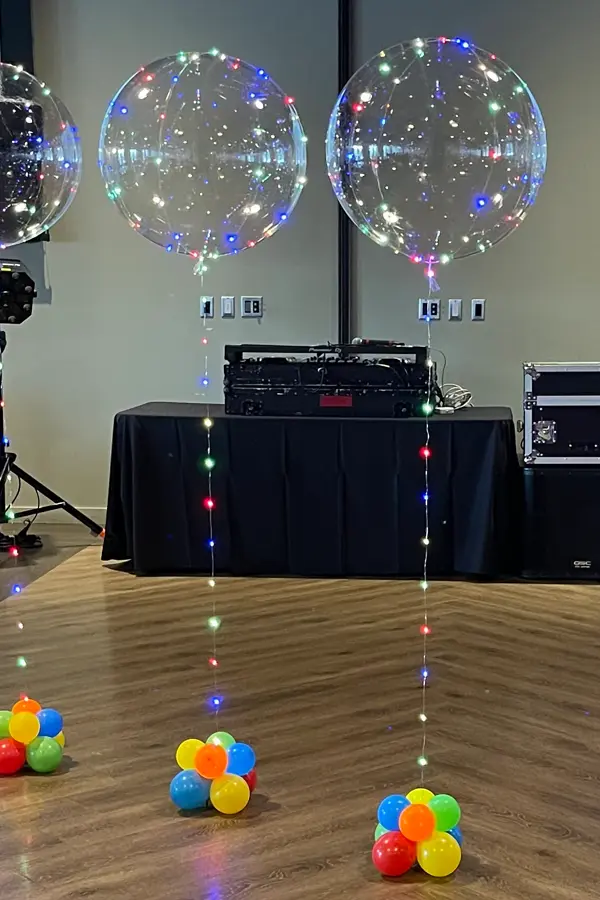 Multi color LED lights wrapped around a clear balloon creating a unique balloon centerpiece
