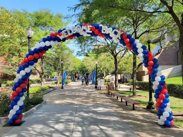 Classic balloon arch with welcome back balloon letters added.