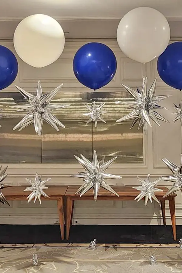 Jumbo helium balloon with two foil starburst accents