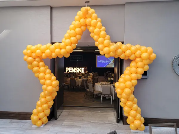 Star shaped balloon arch with mini foil starbursts