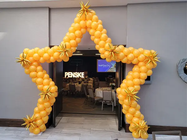 Star shaped balloon arch with mini foil starbursts