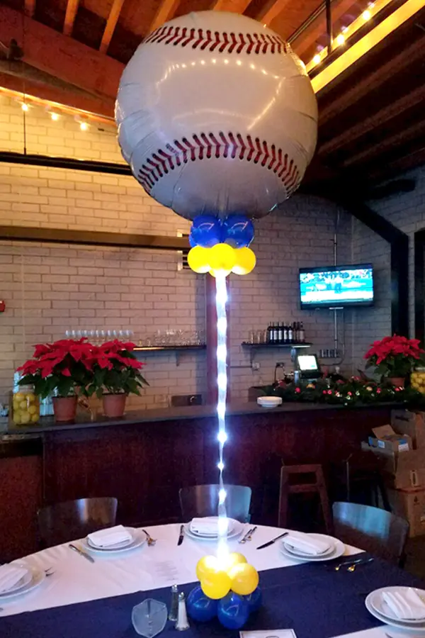 Table centerpiece with jumbo sport ball balloon foil