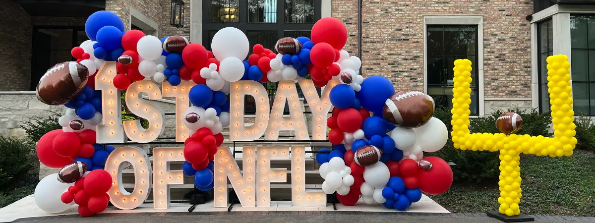 Organic balloon garland with football foils shown on Alpha-Lit letters for the start of the NFL season