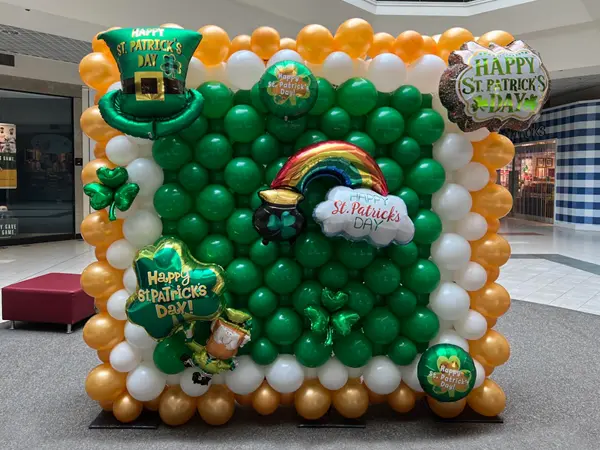 St. Patrick's Day themed balloon wall with foil accents