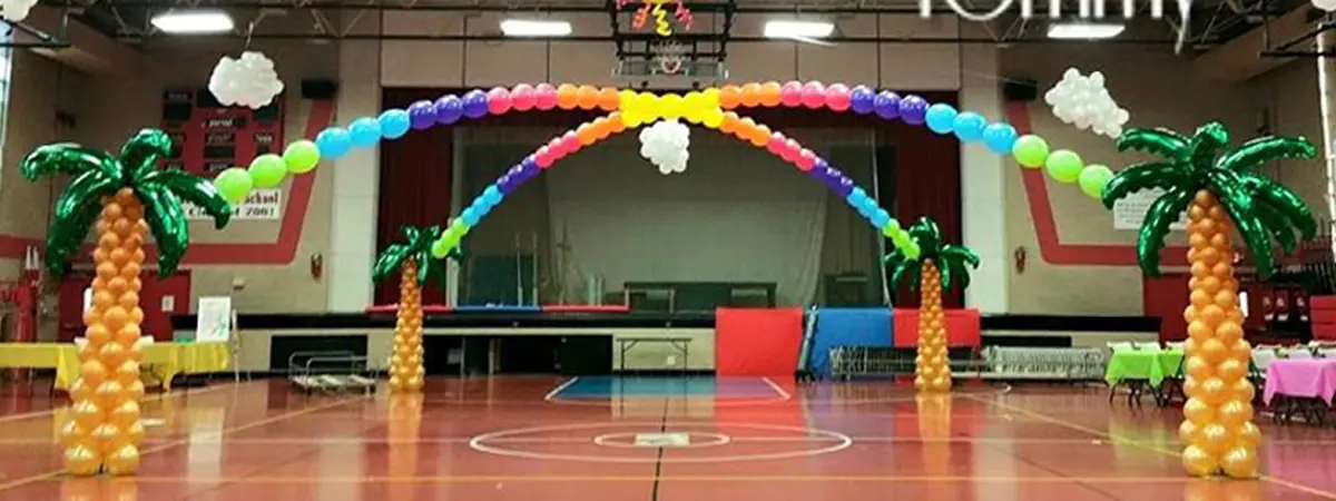 Dance floor balloon arch display with 4 palm tree columns and links creating an arch