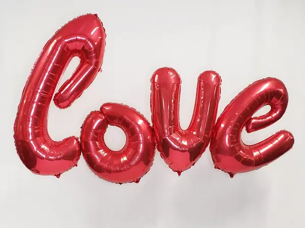 Jumbo 7ft wide foil balloon letters spelling out LOVE