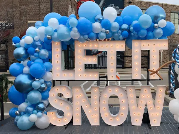 Organic balloon garland in blues on display with Alpha-Lit lettering