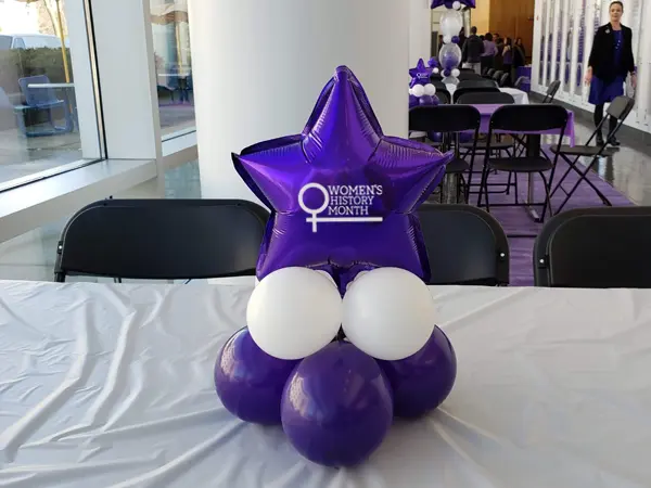 Mini foil balloon centerpiece with Women's History Month logo